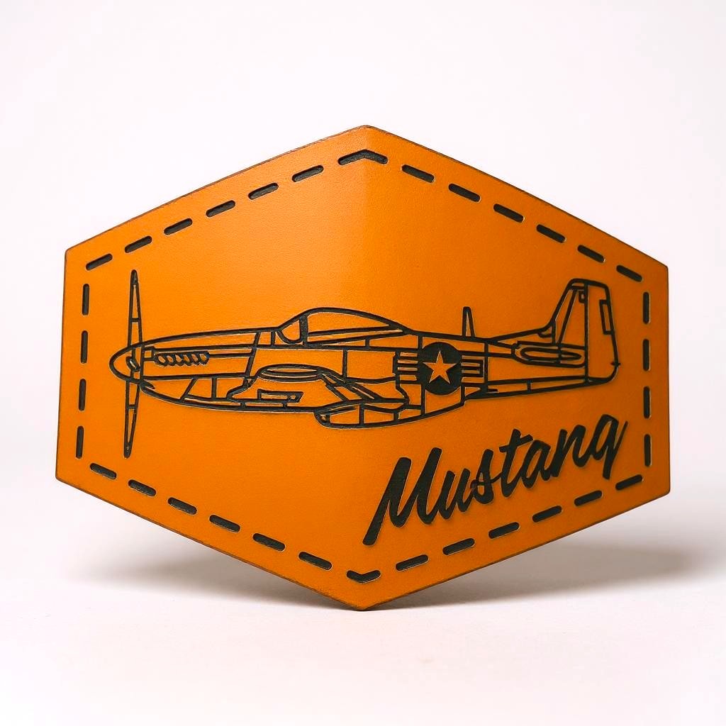 Hexagonal brown leather patch with airplane design and 'Mustang' text on a white background