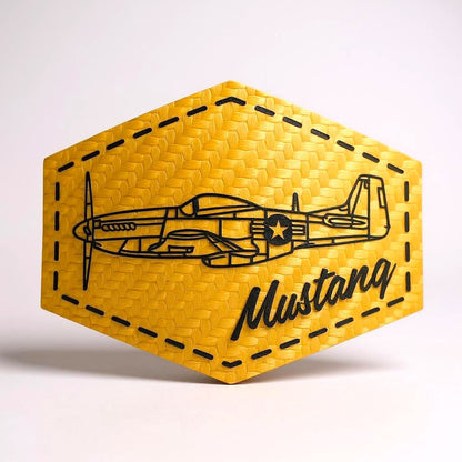 Gold hexagonal patch with airplane design and 'Mustang' text on a white background