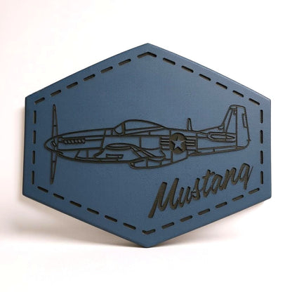Hexagonal blue leather patch with airplane design and 'Mustang' text on a white background